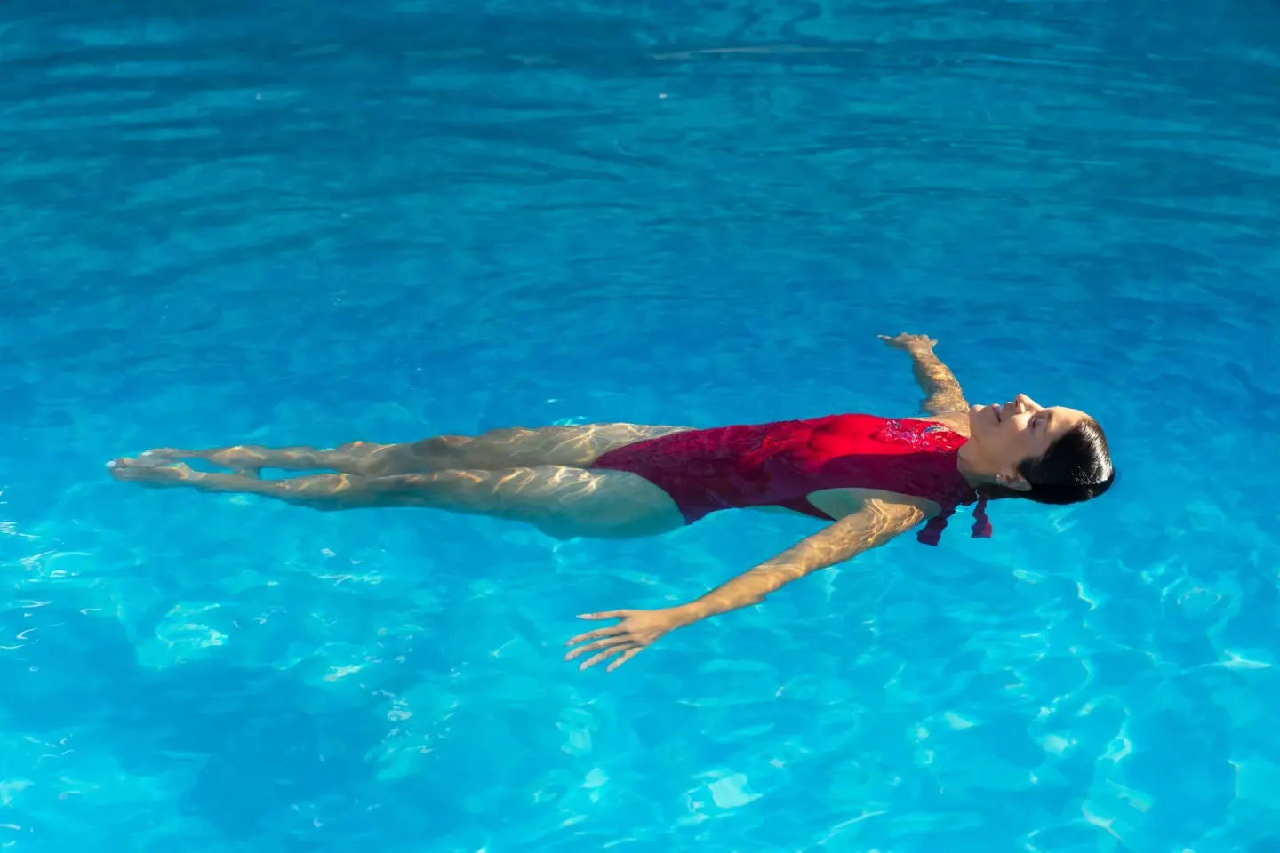Woman floating on her back in the pool at Sheraton Buganvilias Puerto Vallarta.