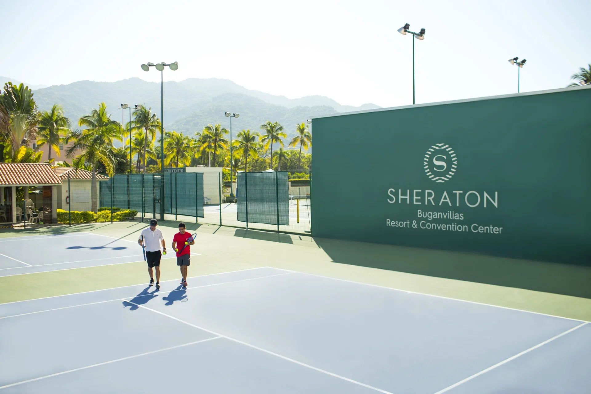 Two players walk across the tennis courts at Sheraton Buganvilias Puerto Vallarta.