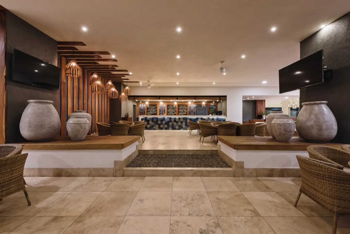 Open bar lounge with wicker chairs and pendant lights at Sheraton Buganvilias Puerto Vallarta.