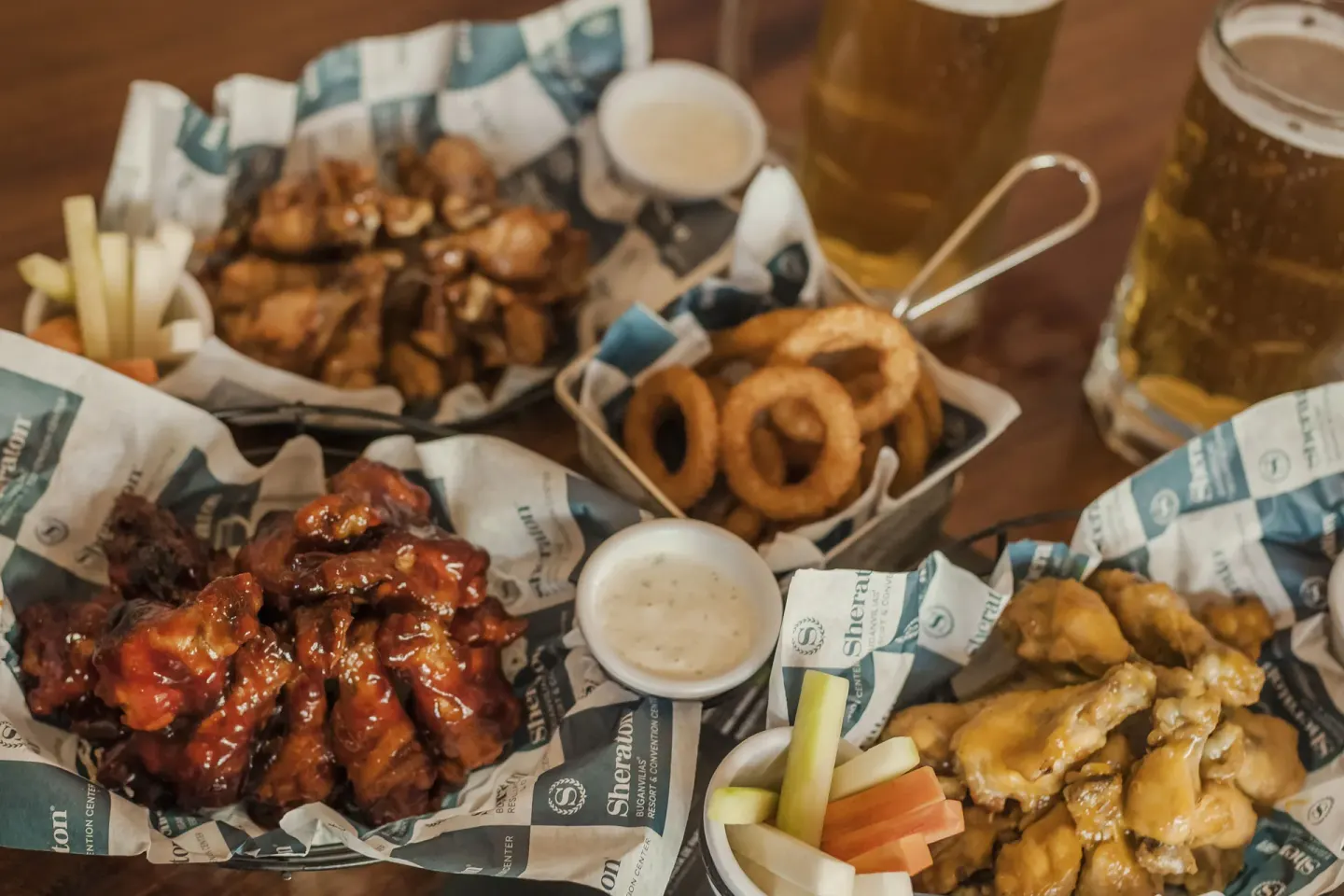 Pub-style wings, onion rings, vegetables, and beer at Sheraton Buganvilias Puerto Vallarta.