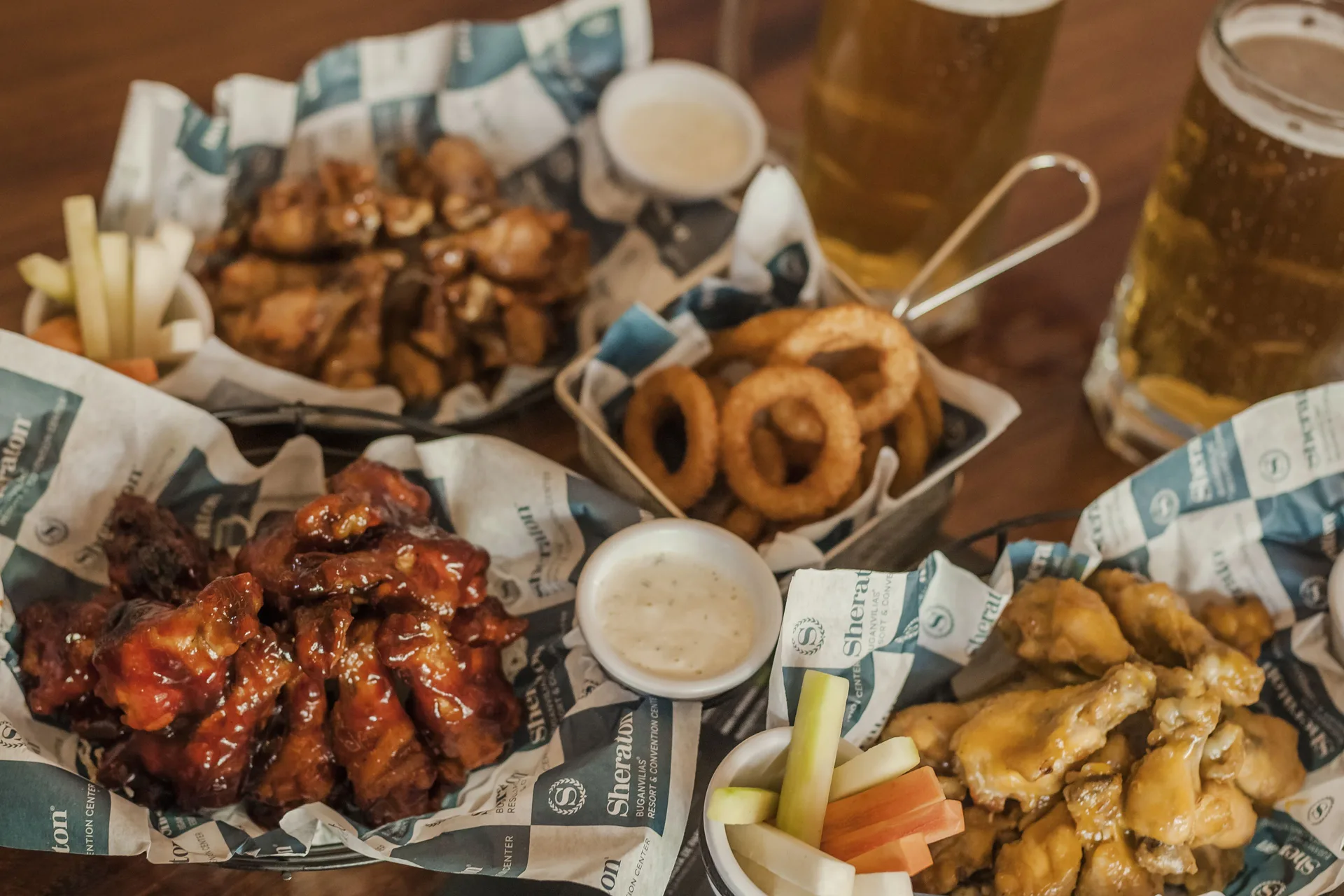 Pub-style wings, onion rings, vegetables, and beer at Sheraton Buganvilias Puerto Vallarta.