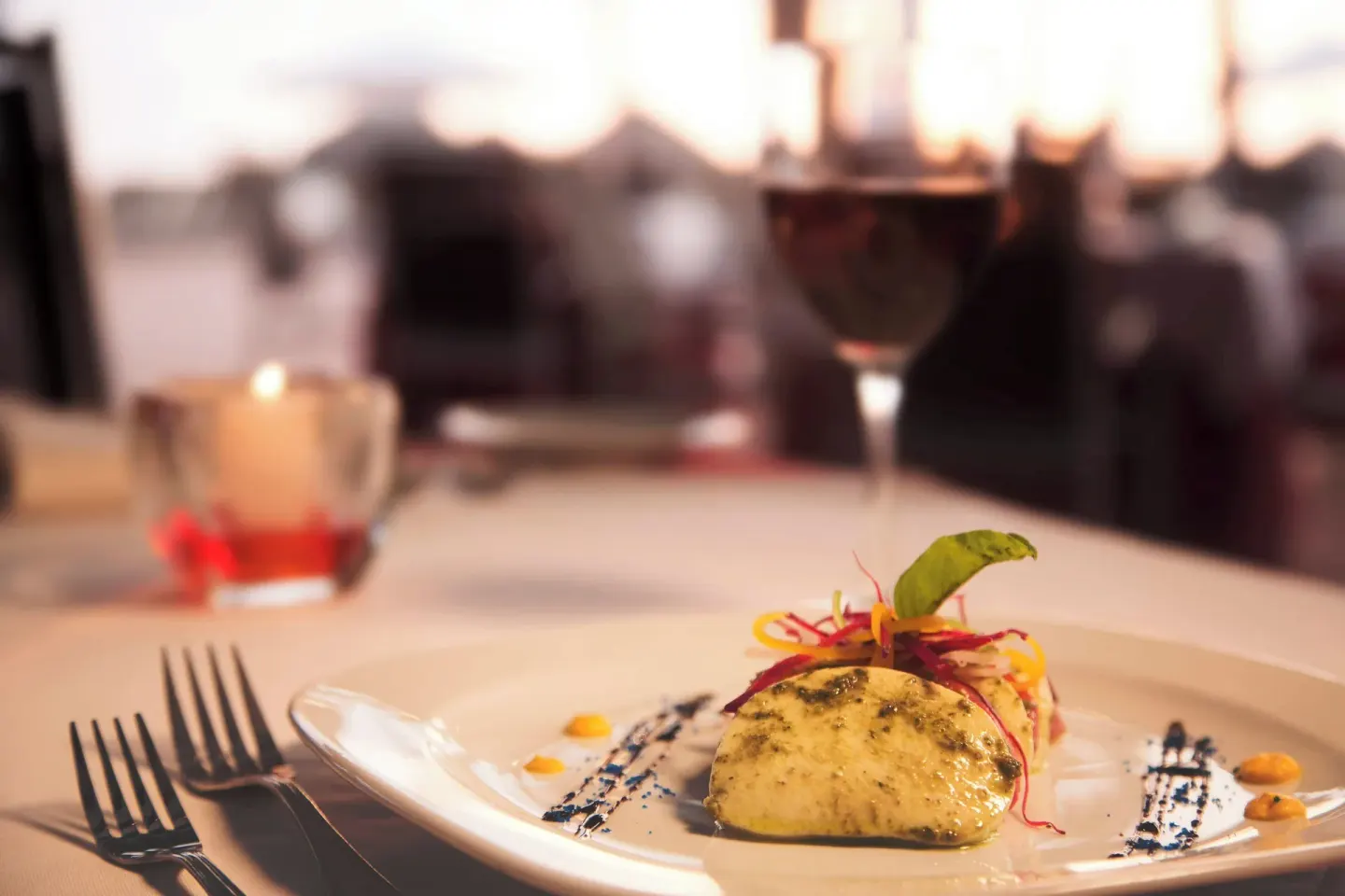 Plated entrée with wine and candlelight at Sheraton Buganvilias Puerto Vallarta.