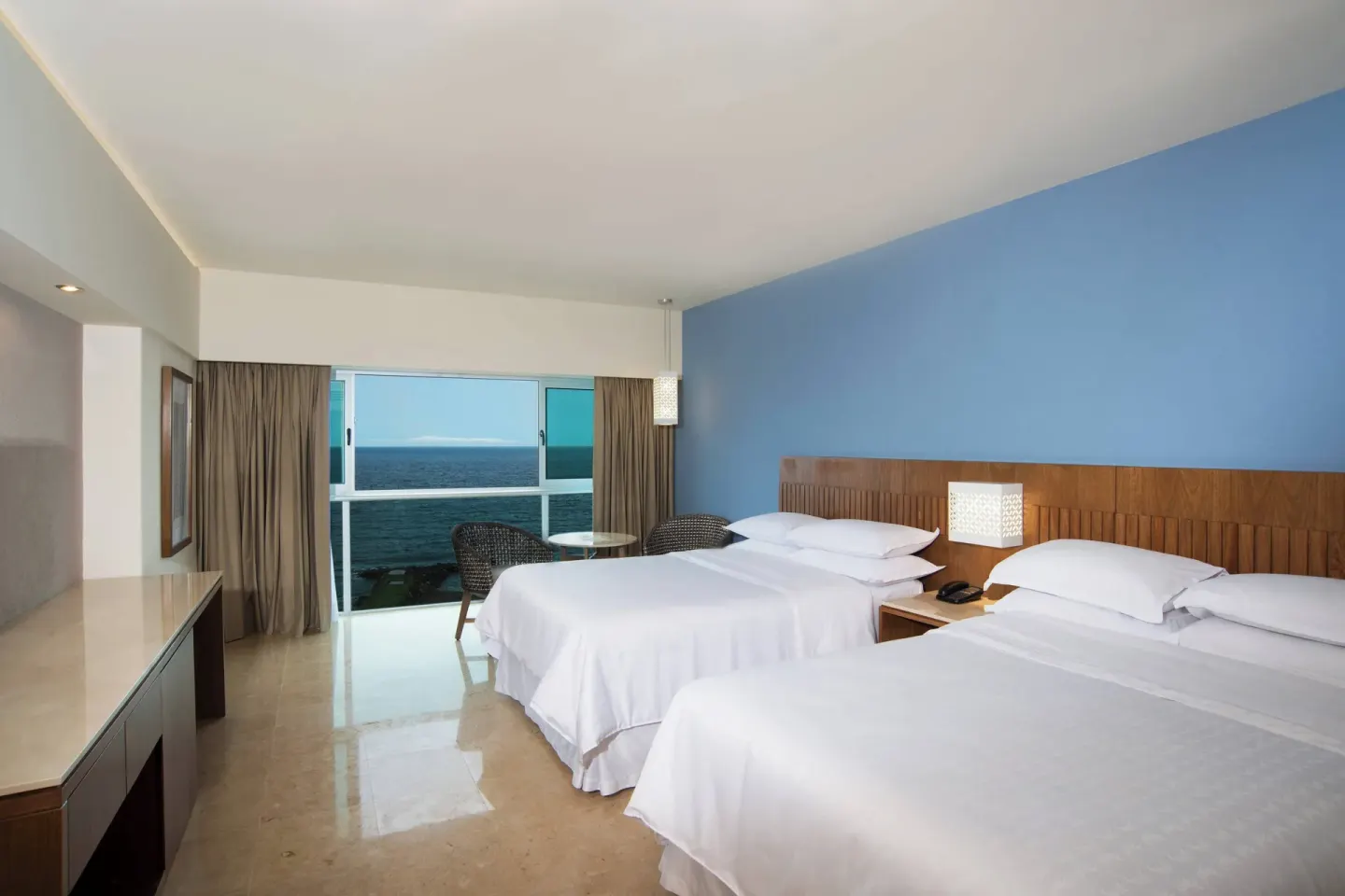Deluxe Ocean View room with two double beds at Sheraton Buganvilias Puerto Vallarta.