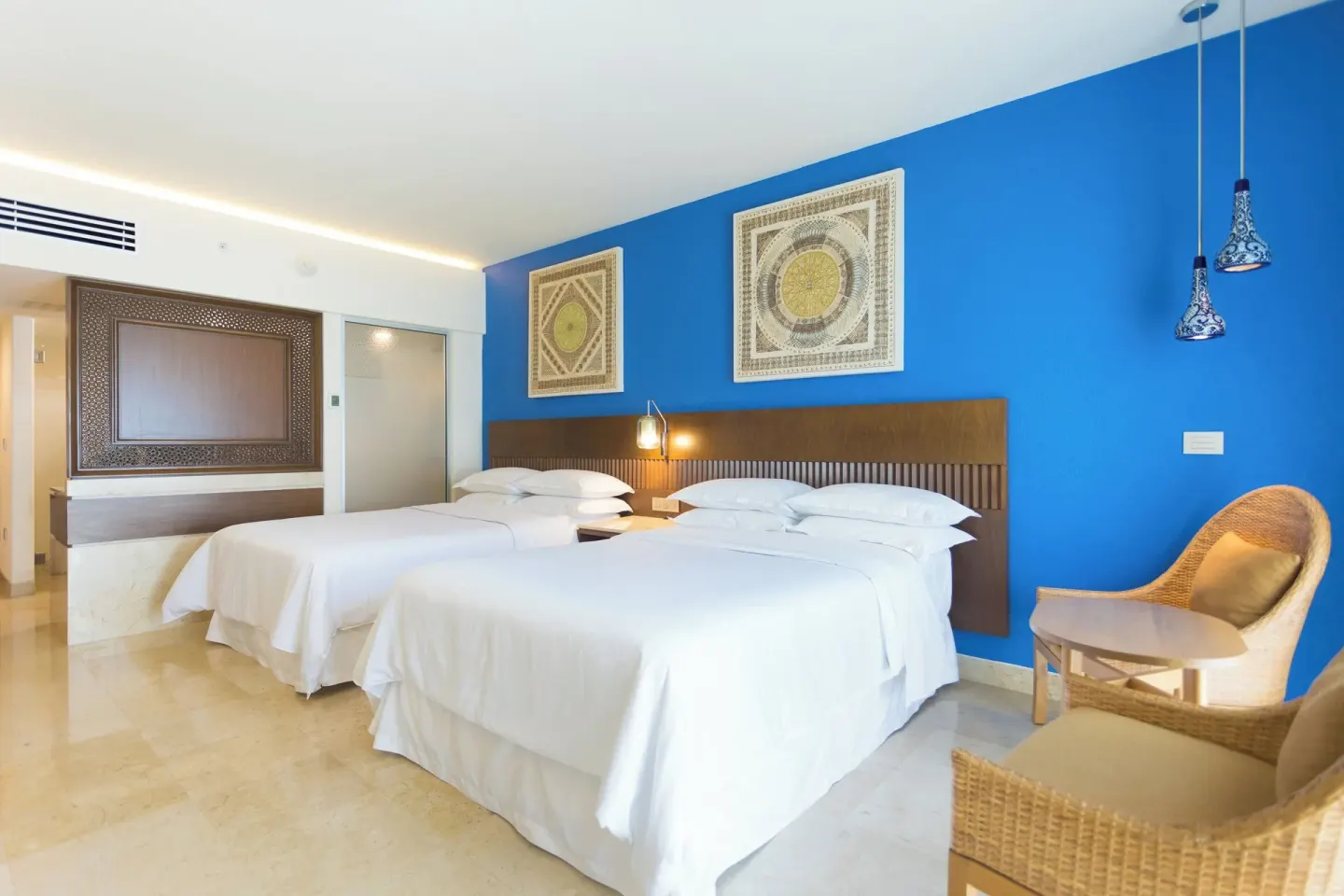 Signature Room with two beds and blue accent wall at Sheraton Buganvilias Puerto Vallarta.