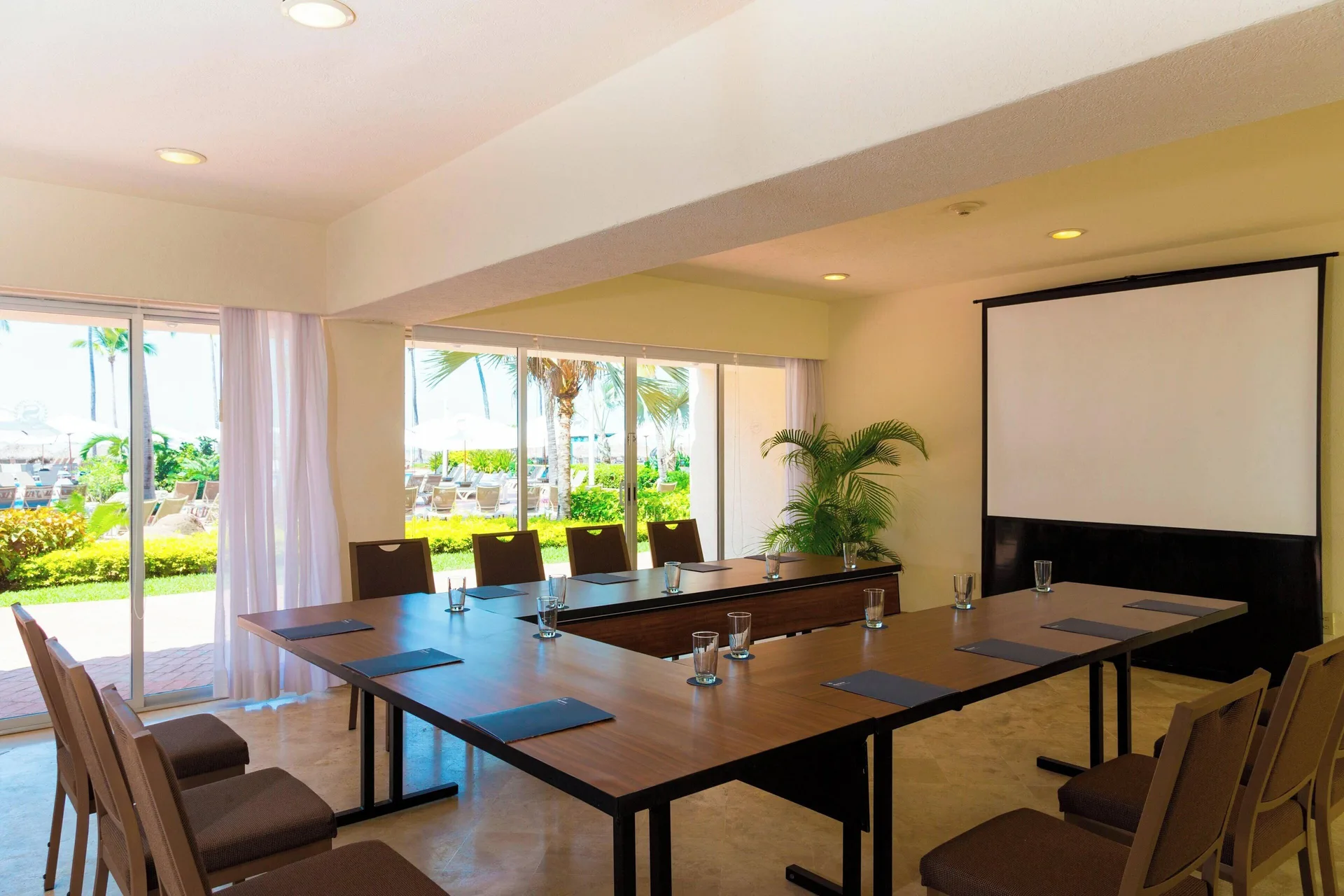Meeting room with U-shaped tables and garden windows at Sheraton Buganvilias Puerto Vallarta.