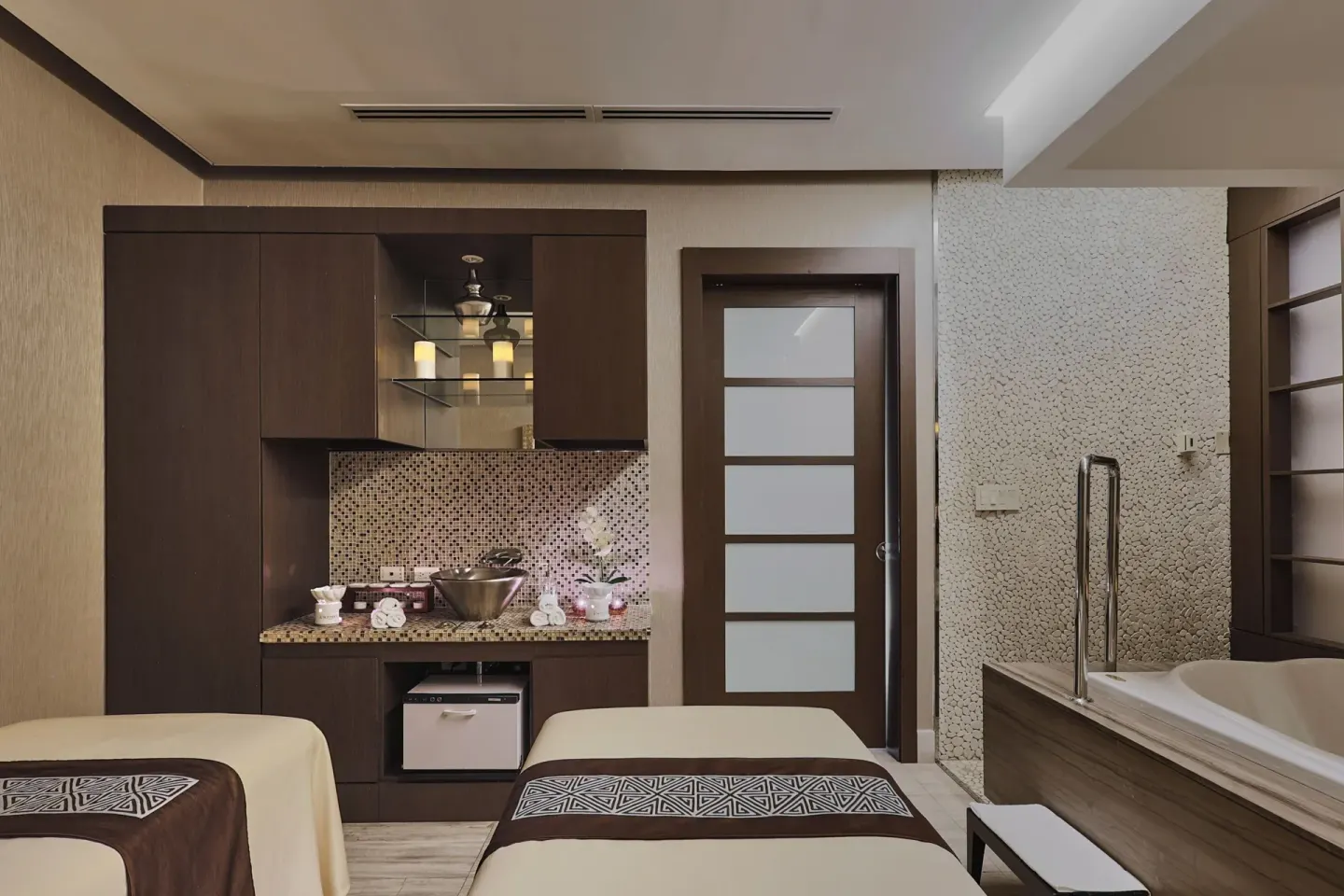 Couples treatment room with two massage beds and a soaking tub at Sheraton Grand Panama.