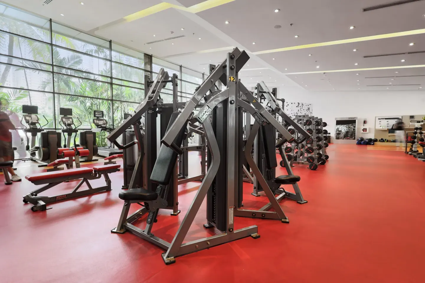 Gym strength machines beside tall windows at Sheraton Grand Panama.