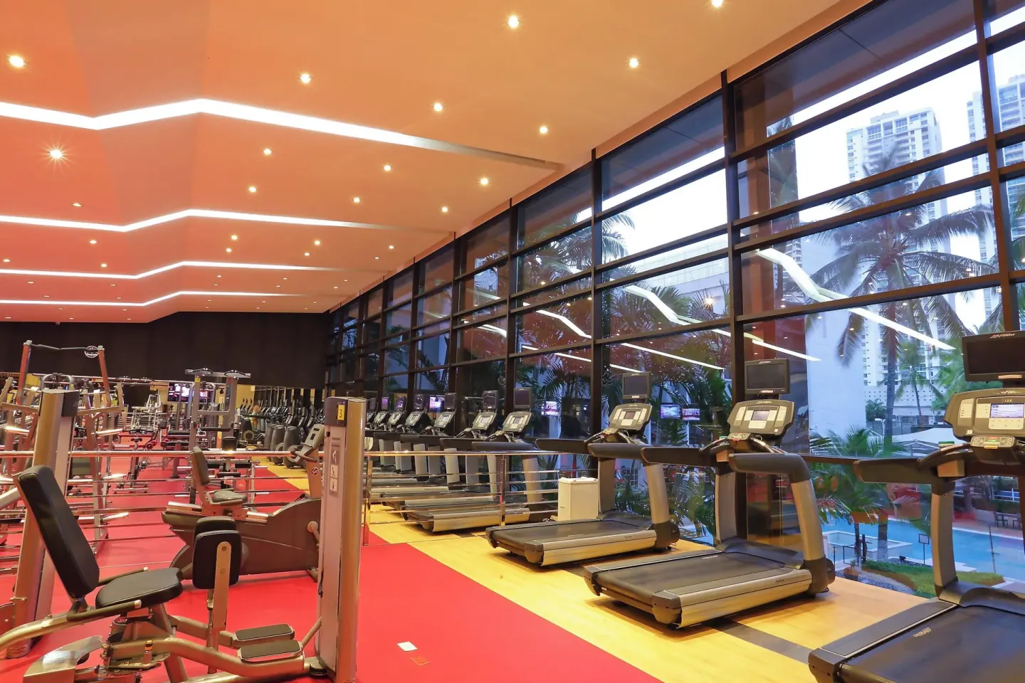 Treadmills beside large evening windows at Sheraton Grand Panama.