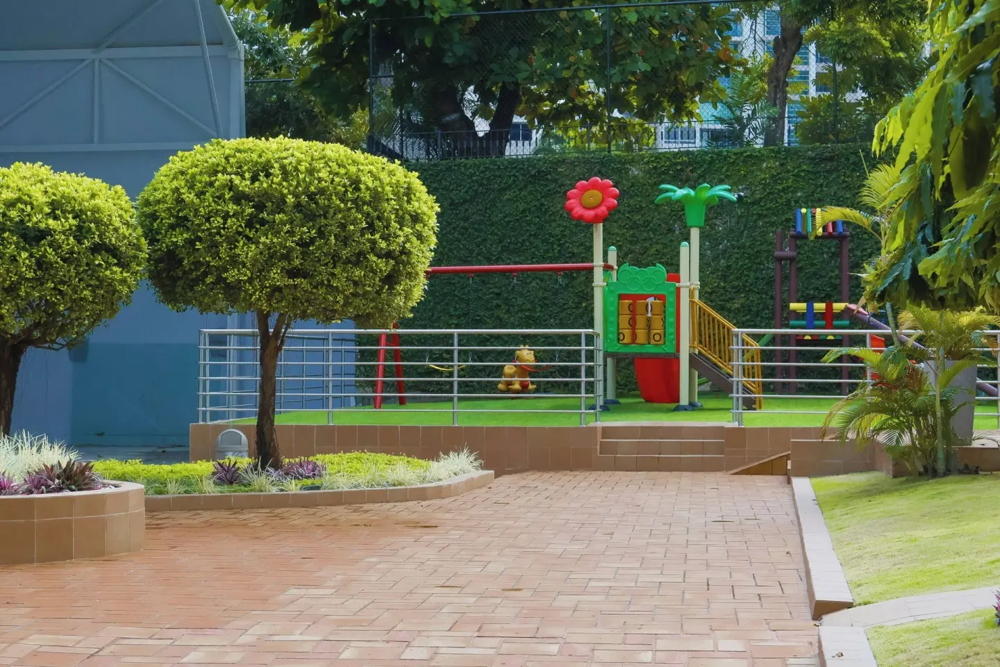 Landscaped walkway leading to a children's playground at Sheraton Grand Panama.