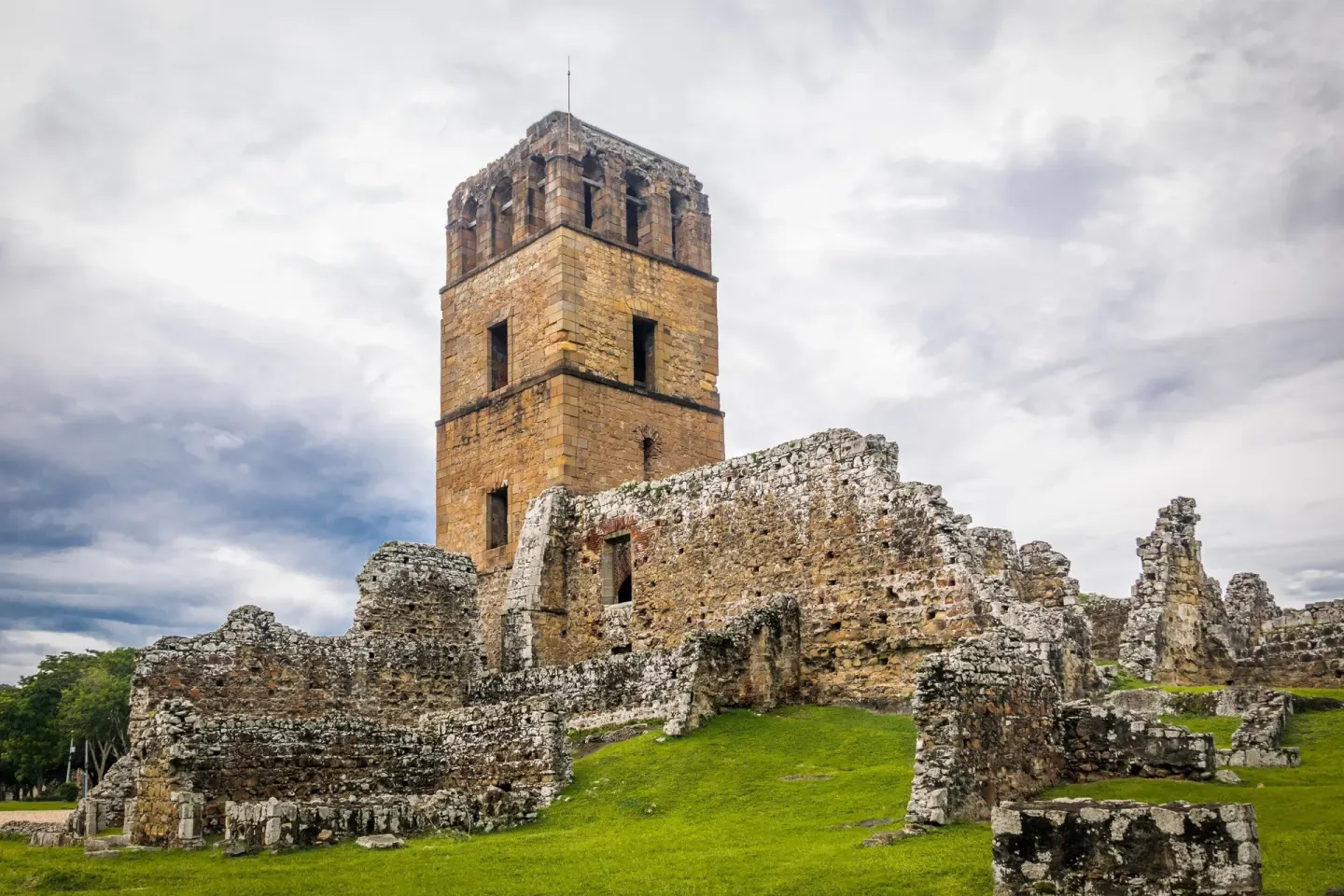 Historic stone ruins and tower near Sheraton Grand Panama under cloudy skies.