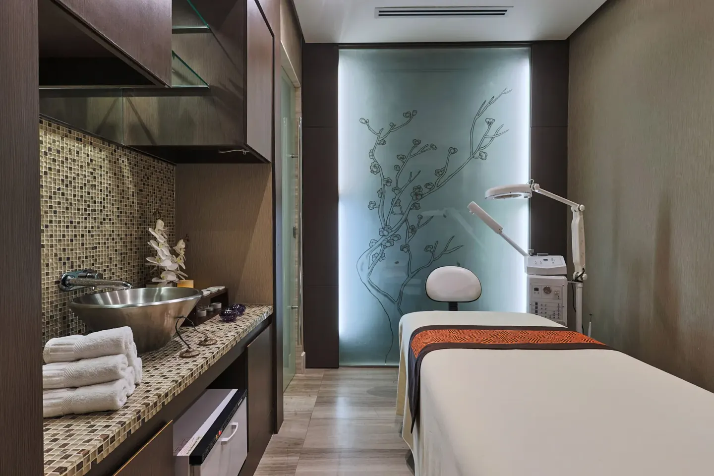 Narrow spa treatment room with massage bed and equipment at Sheraton Grand Panama.