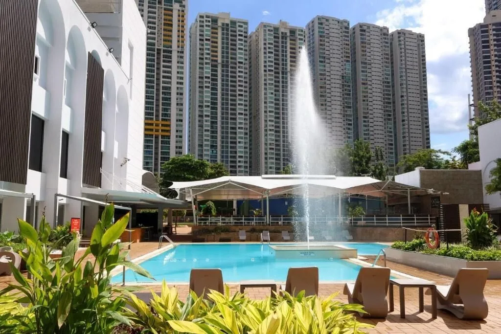 Outdoor pool with fountain and lounge chairs at Sheraton Grand Panama.