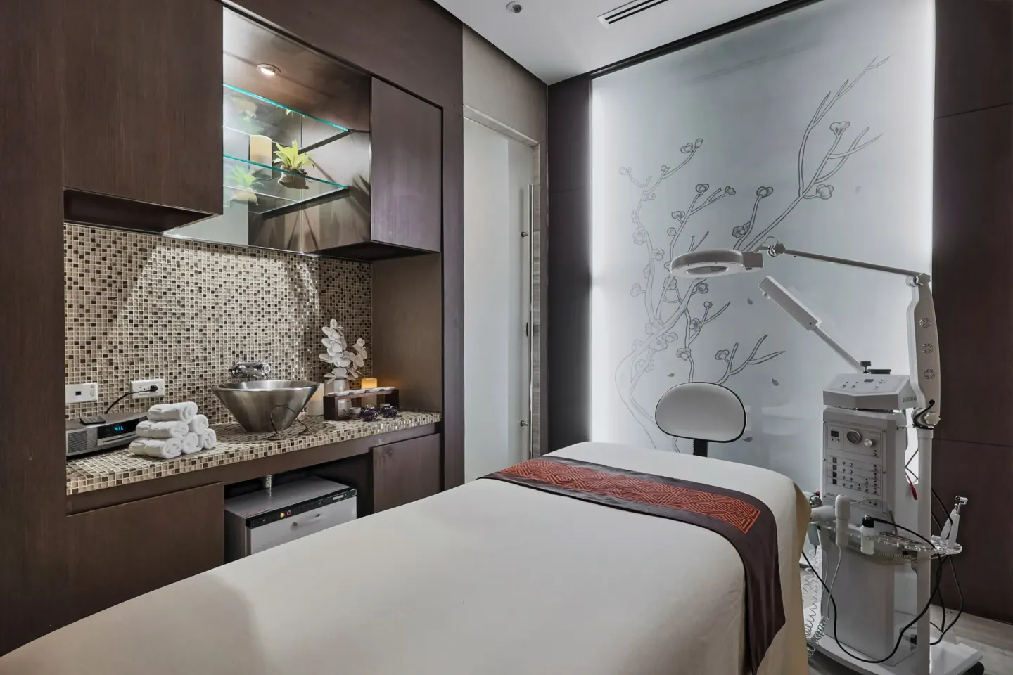 Spa treatment room with facial equipment and a single bed at Sheraton Grand Panama.