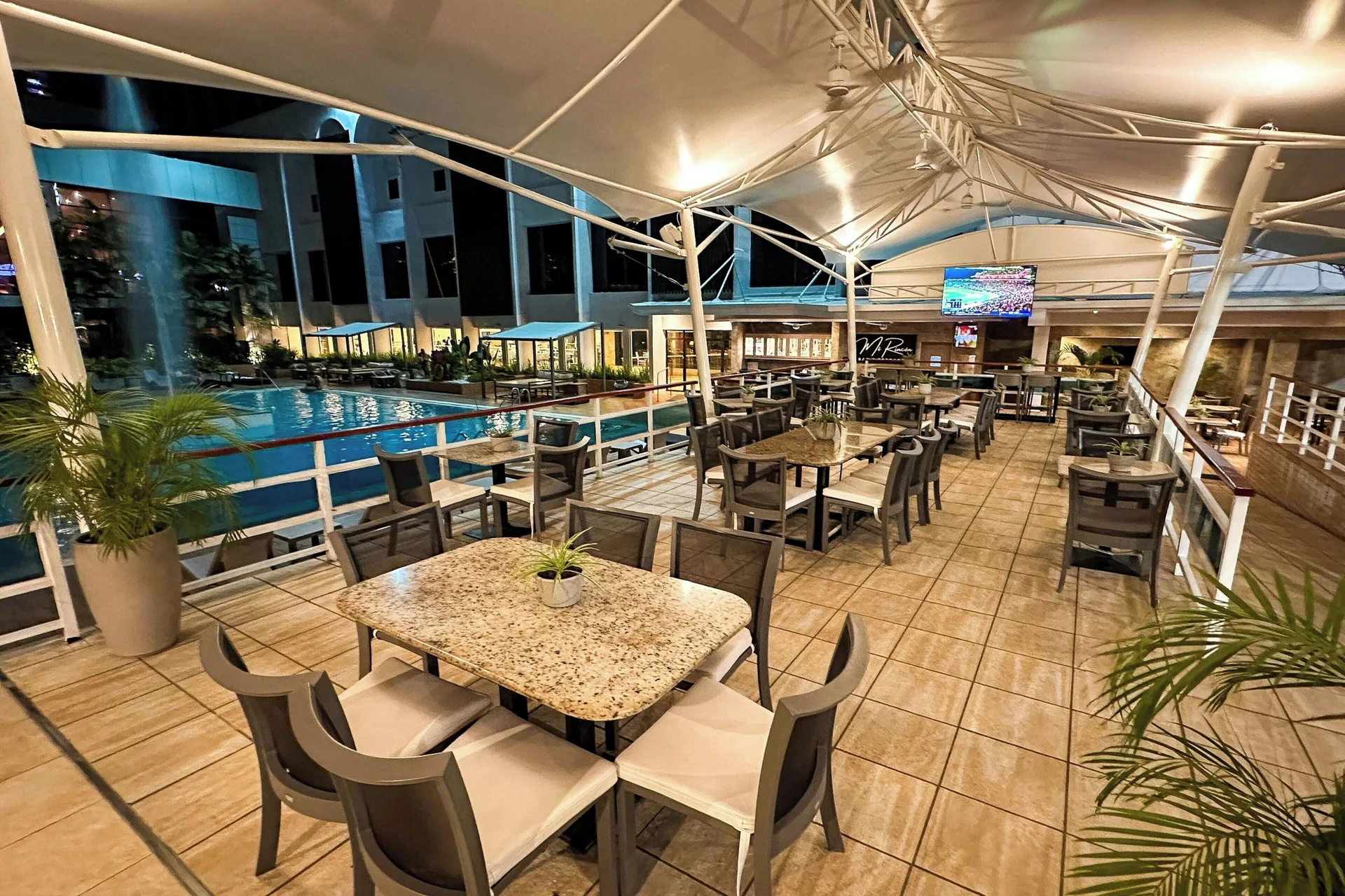 Covered poolside grill seating at night at Sheraton Grand Panama.