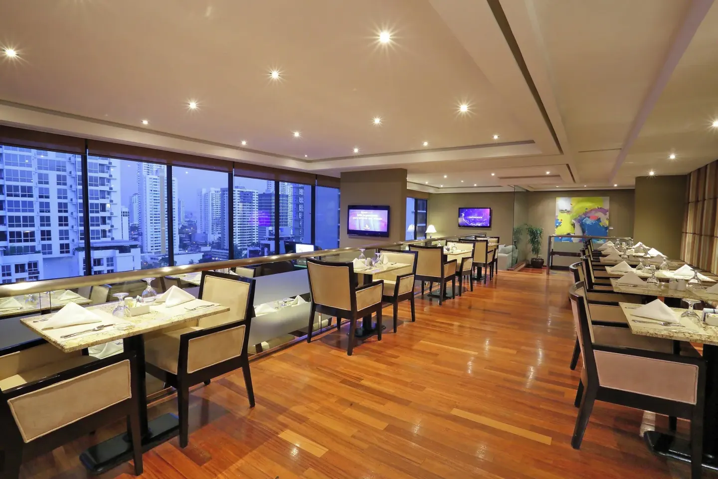 Club lounge tables, city windows and wall art at Sheraton Grand Panama.