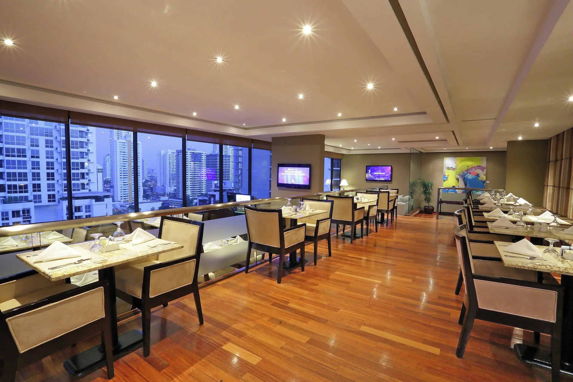 Club lounge tables, city windows and wall art at Sheraton Grand Panama.