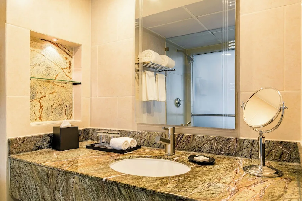 Deluxe room bathroom vanity with marble counter and mirror at Sheraton Grand Panama.