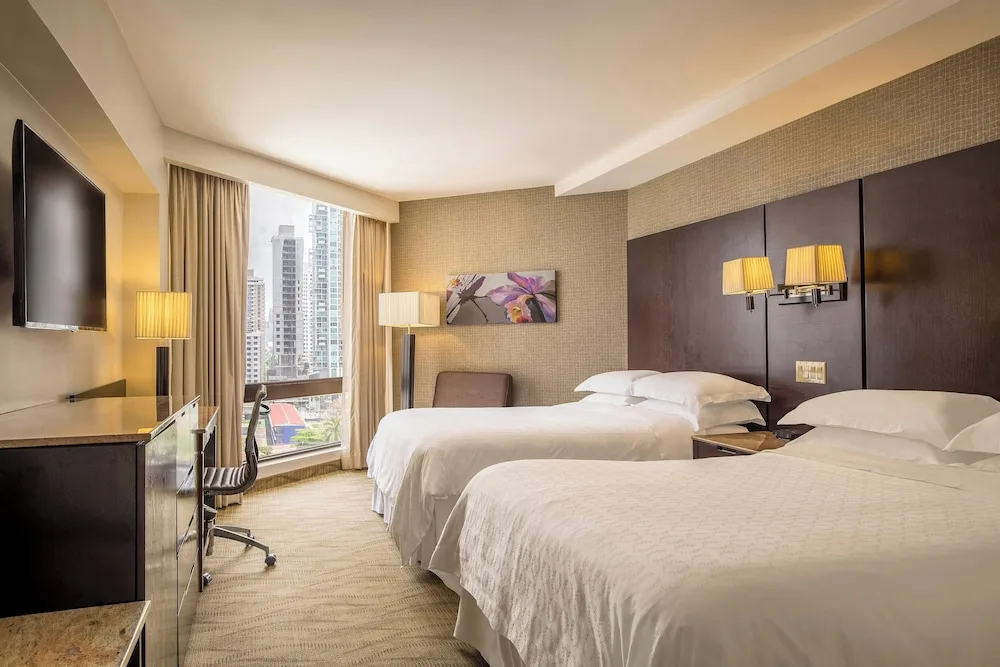 Deluxe room with two beds and city-facing window at Sheraton Grand Panama.