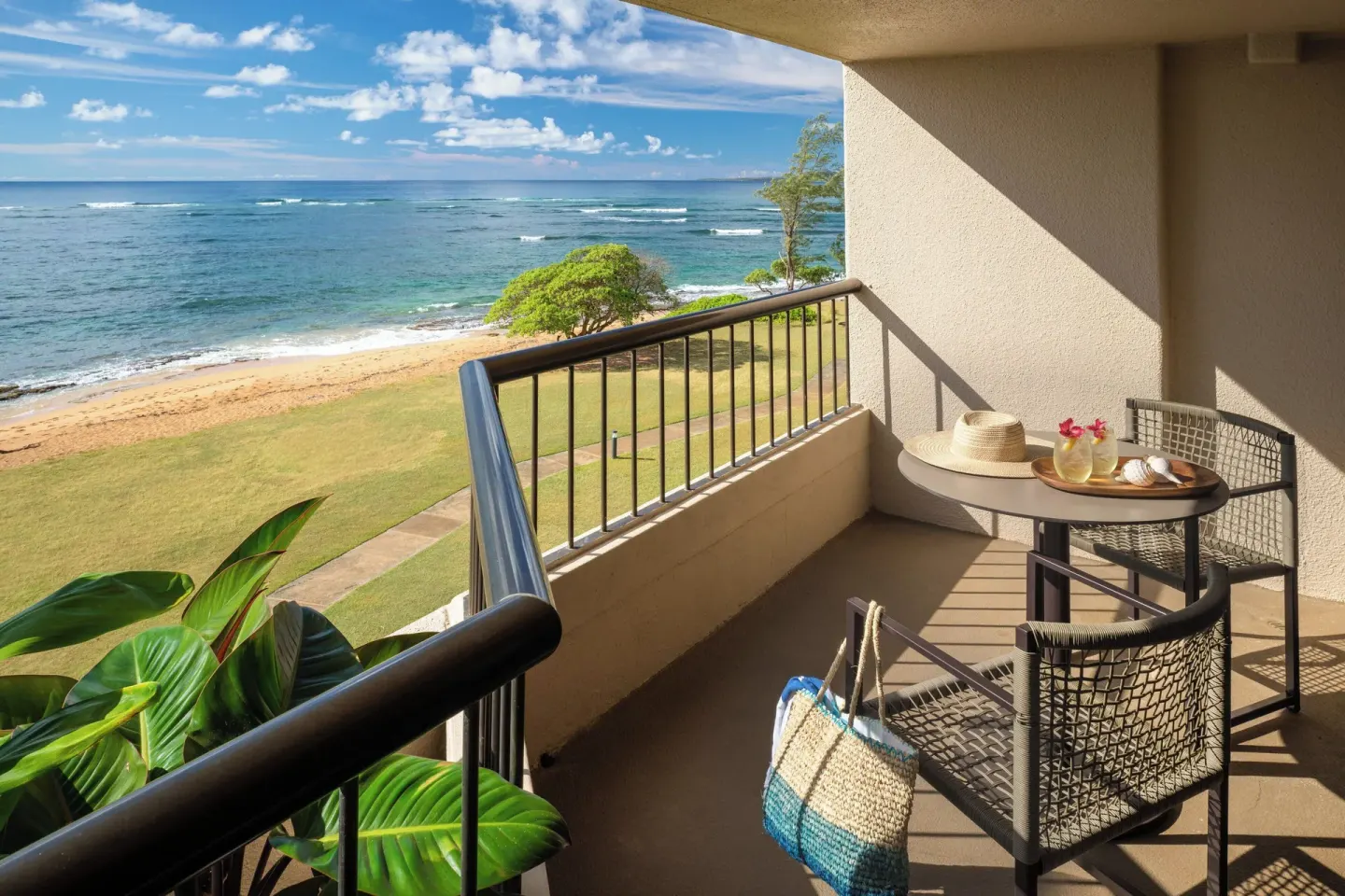 Oceanfront balcony seating at Sheraton Kauai Coconut Beach Resort.