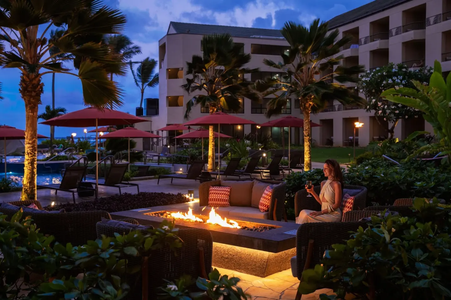 Evening fire pit seating by the pool at Sheraton Kauai Coconut Beach Resort.