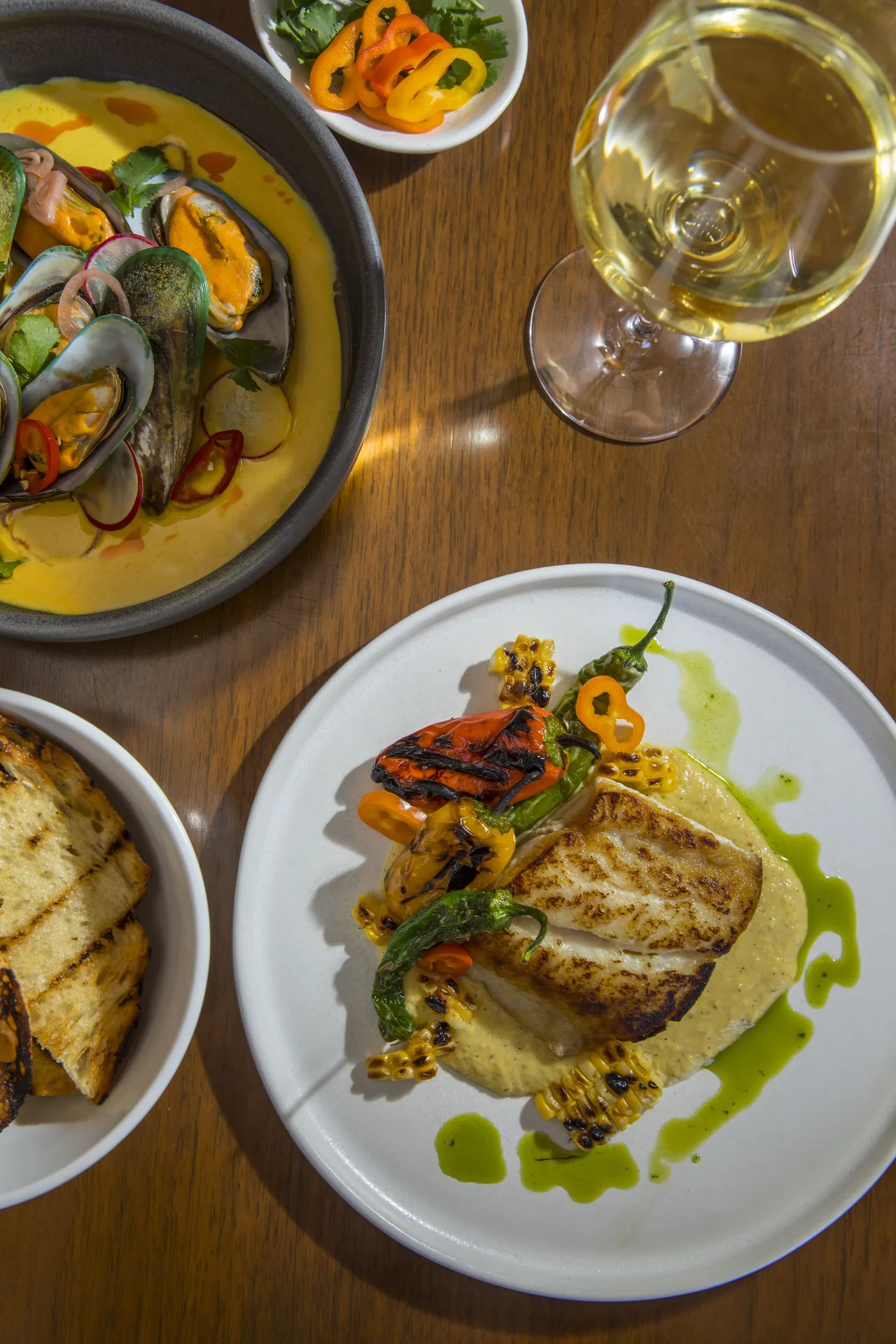 Seafood dishes and a glass of white wine at Sheraton Kauai Coconut Beach Resort.