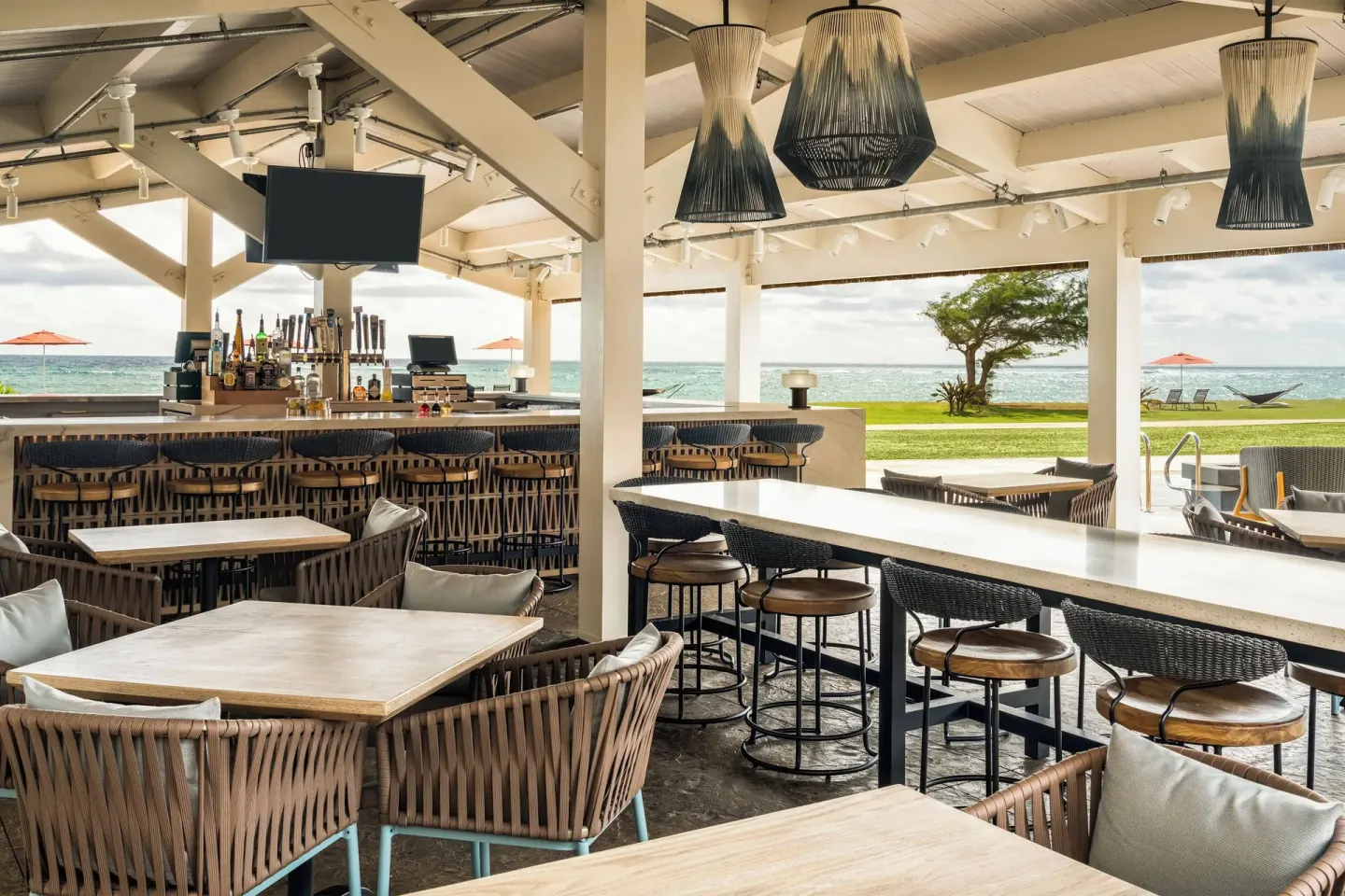 Open-air oceanfront bar and dining area at Sheraton Kauai Coconut Beach Resort.