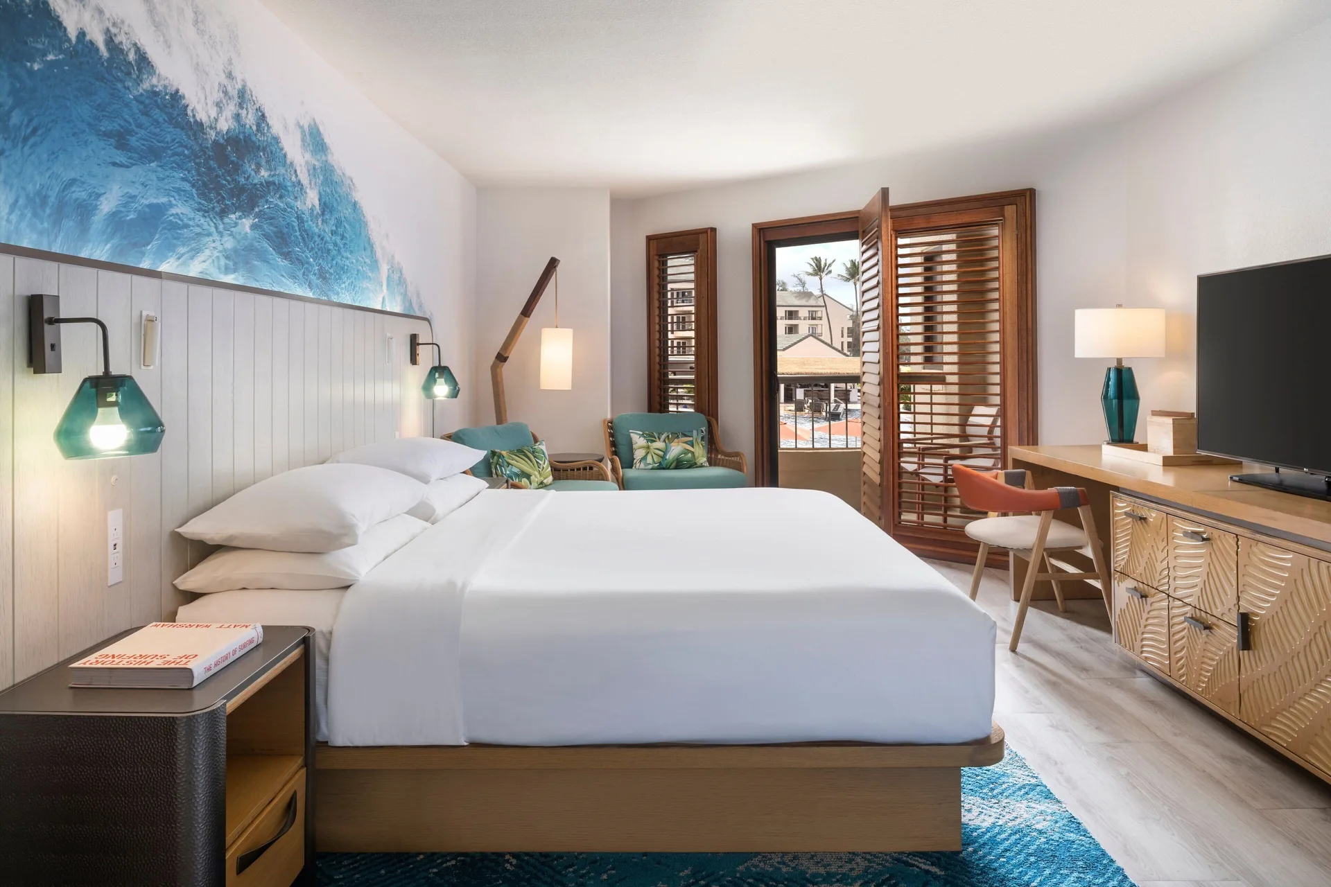 Partial ocean view king room with balcony shutters at Sheraton Kauai Coconut Beach Resort.