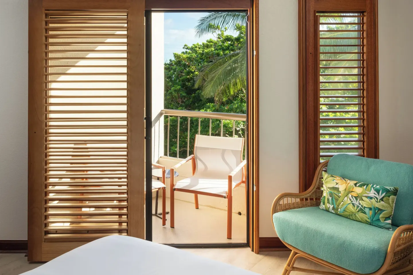 Standard room balcony doorway and lounge chair at Sheraton Kauai Coconut Beach Resort.