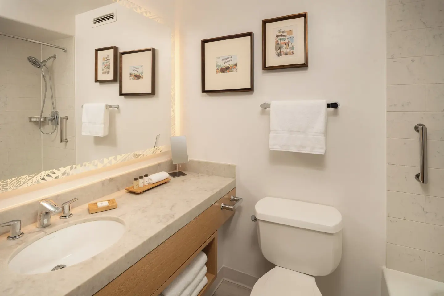 Standard Room bathroom with vanity, toilet and shower at Sheraton Kauai Coconut Beach Resort.