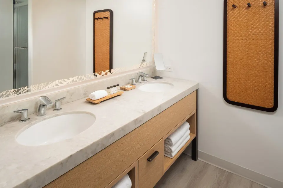 Standard room bathroom vanity with two sinks at Sheraton Kauai Coconut Beach Resort.