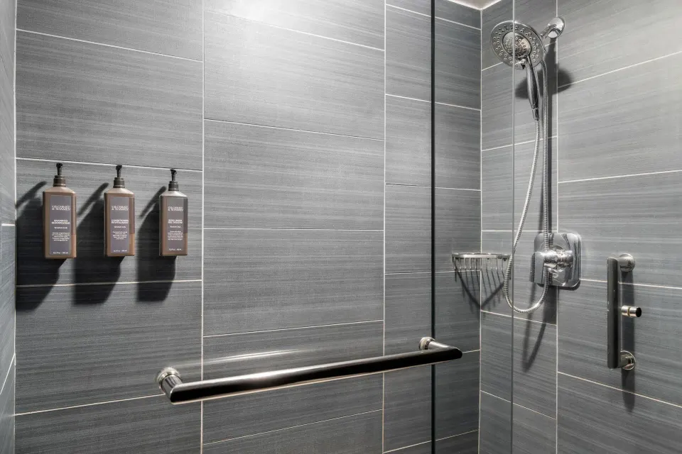 Standard Room glass shower with gray tile at Sheraton Kauai Coconut Beach Resort.