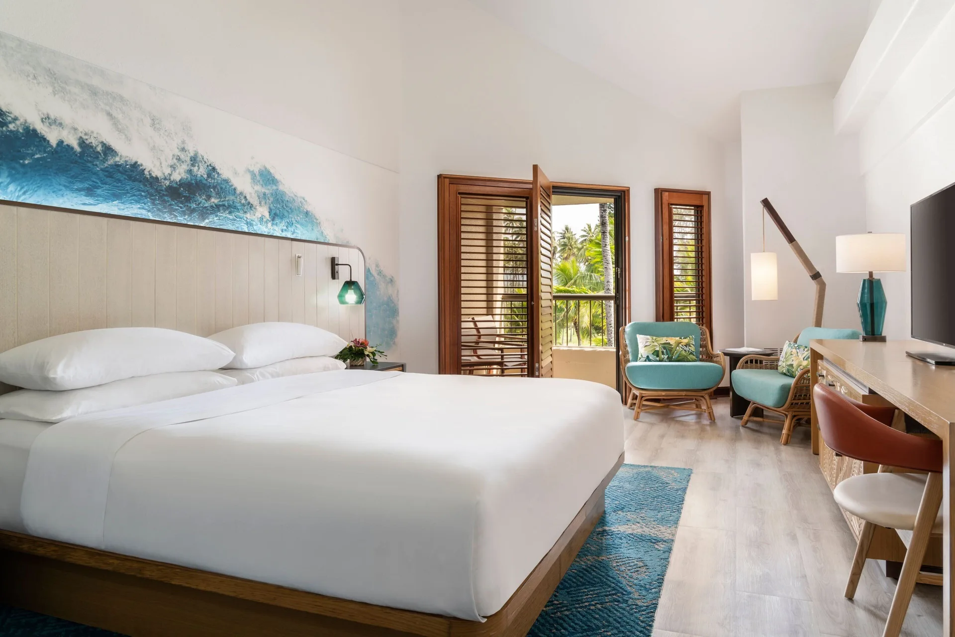 Standard Room with king bed and sitting area at Sheraton Kauai Coconut Beach Resort featuring comfortable furnishings and relaxed Hawaiian décor.