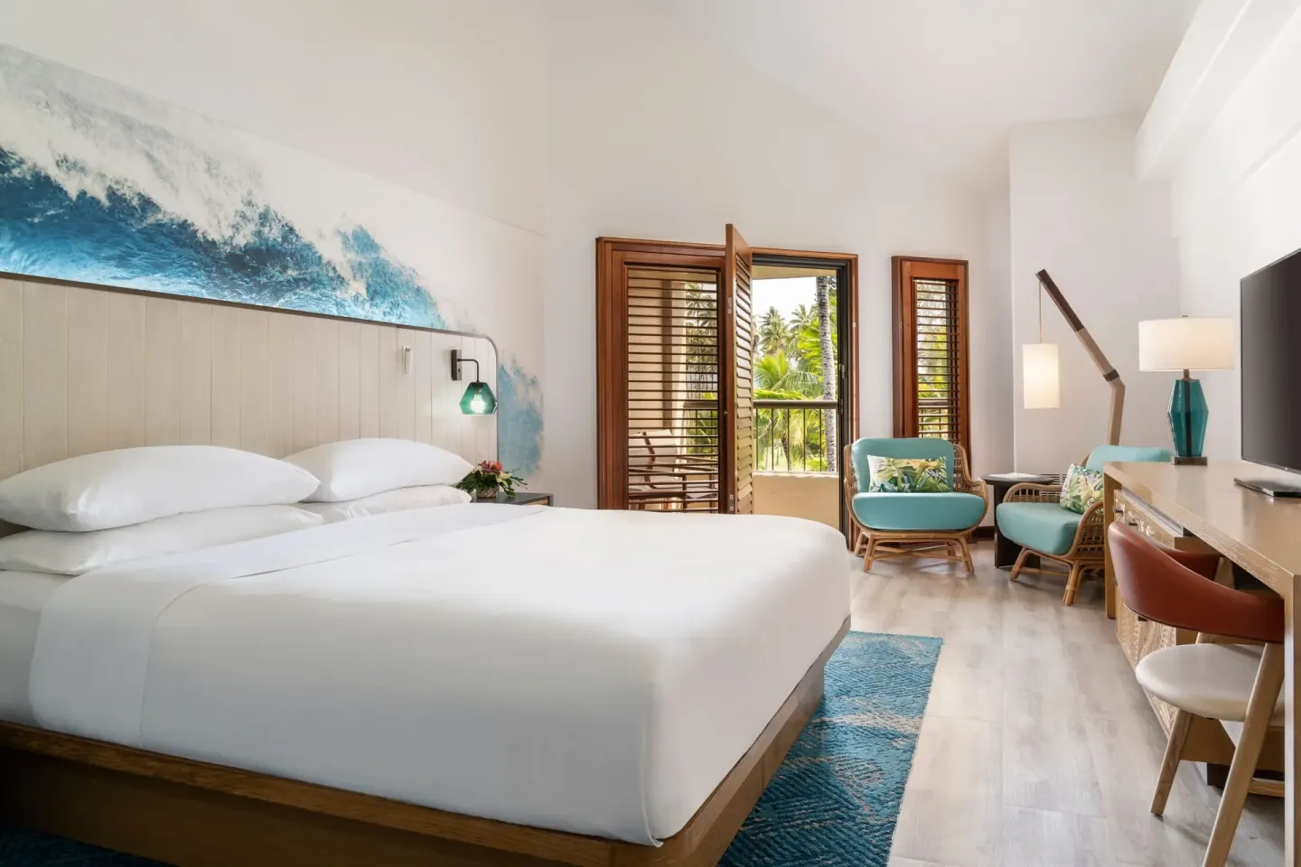 Standard room with king bed and sitting area at Sheraton Kauai Coconut Beach Resort.