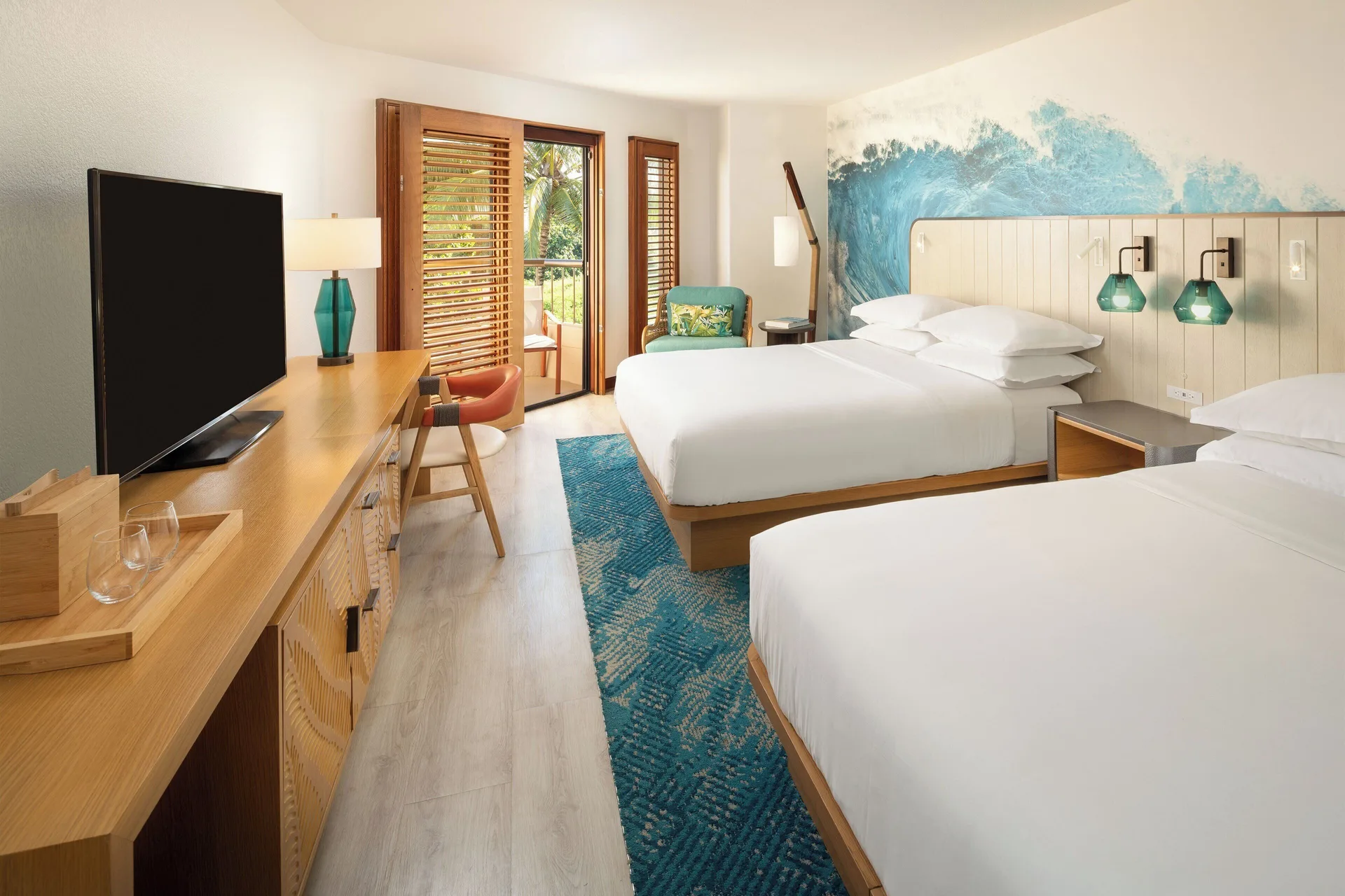 Standard room with two beds and wave mural at Sheraton Kauai Coconut Beach Resort.