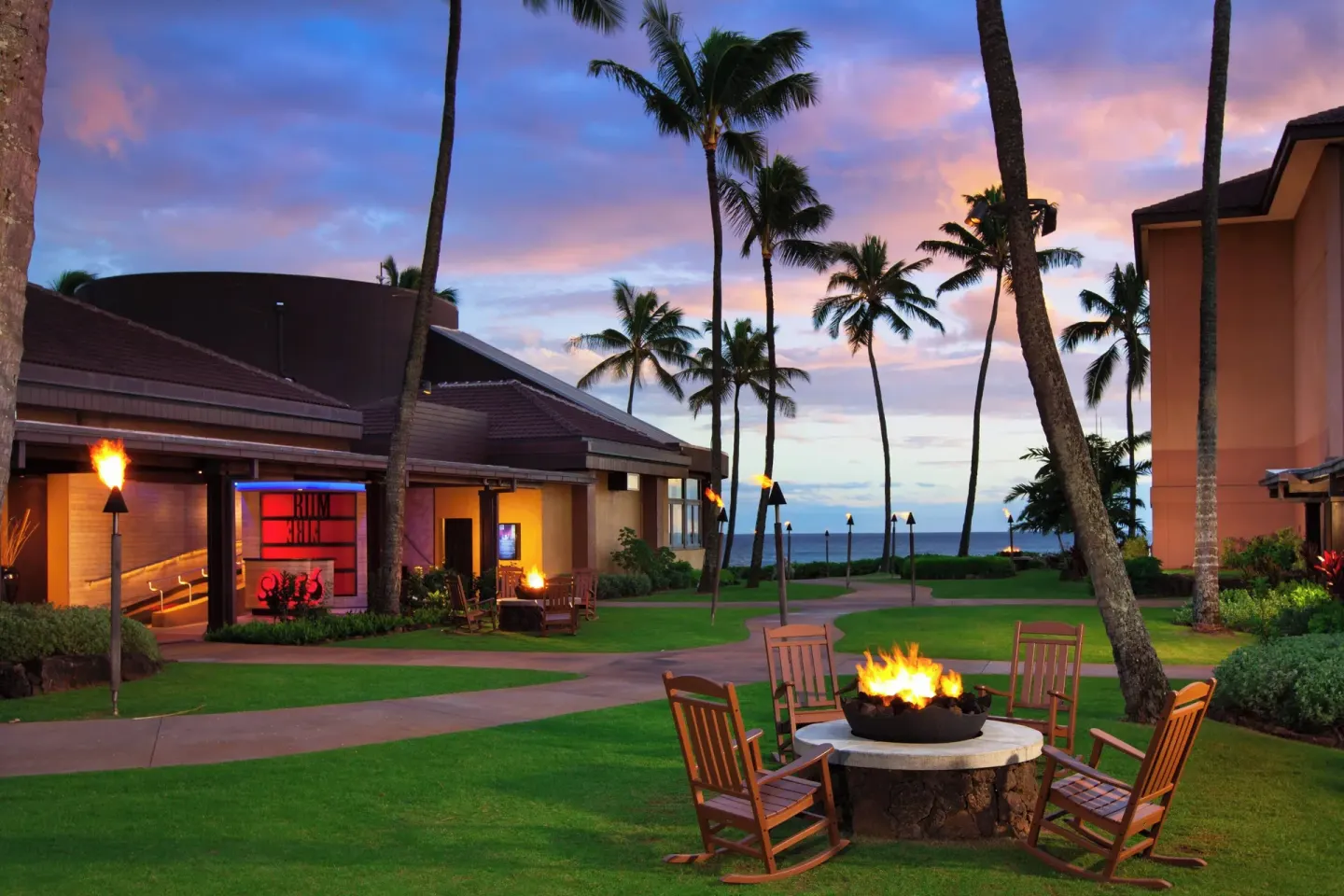 Fire pit seating on the lawn near RumFire Poipu Beach at Sheraton Kauai Resort.