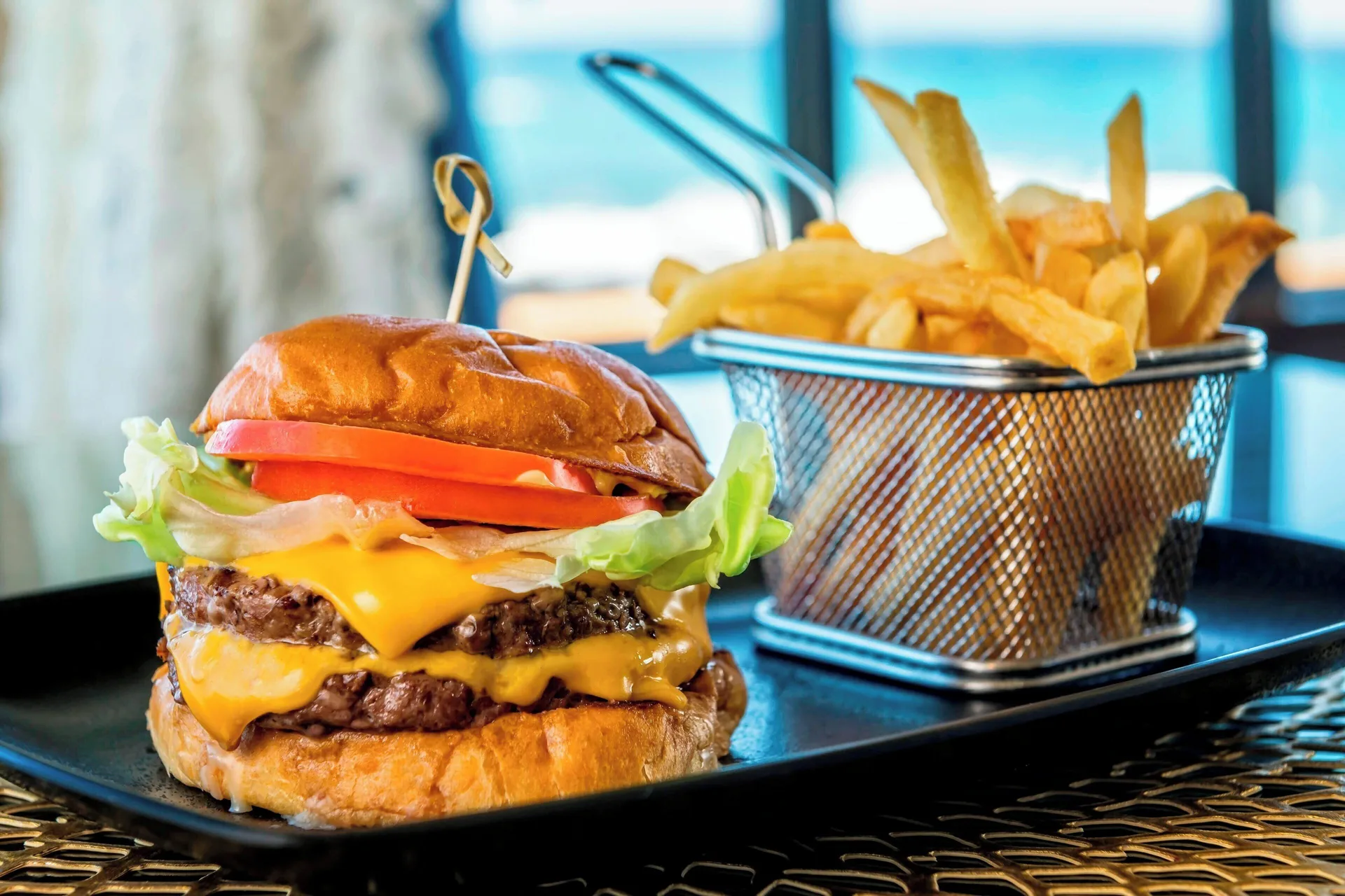 Cheeseburger with fries in a basket at Sheraton Kauai Resort.