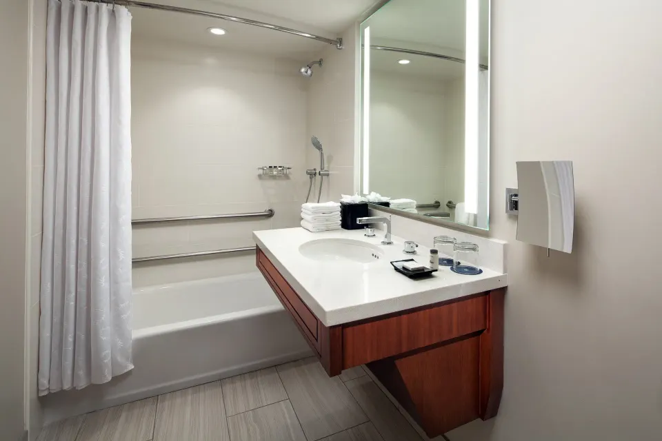 Deluxe Room Garden View bathroom with tub and vanity at Sheraton Kauai Resort.