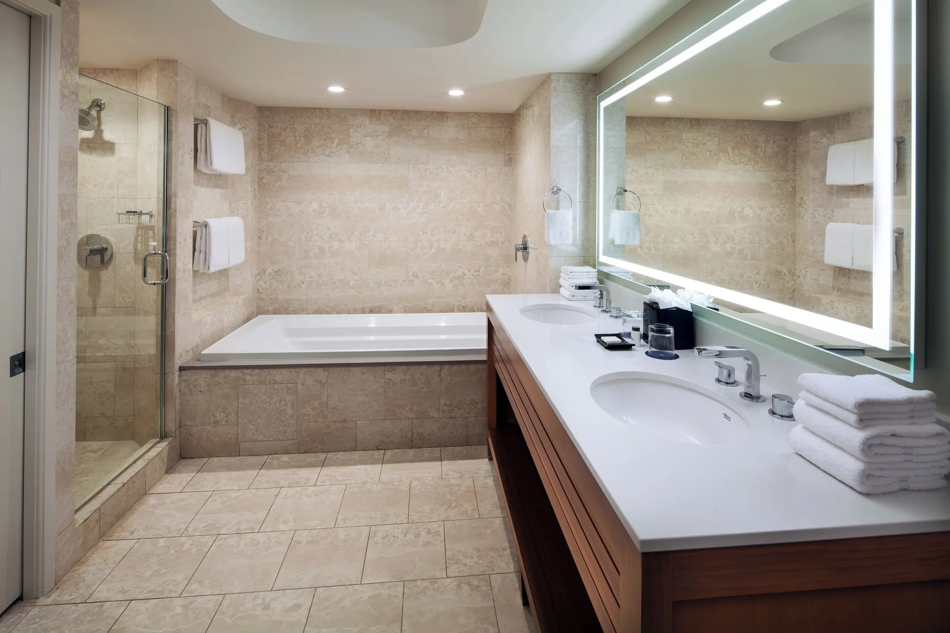 Deluxe suite bathroom with double vanity, soaking tub, and shower at Sheraton Kauai Resort.