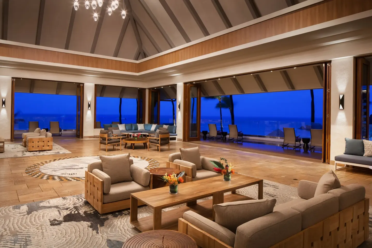 Evening open-air lobby lounge with ocean views at Sheraton Maui Resort & Spa.