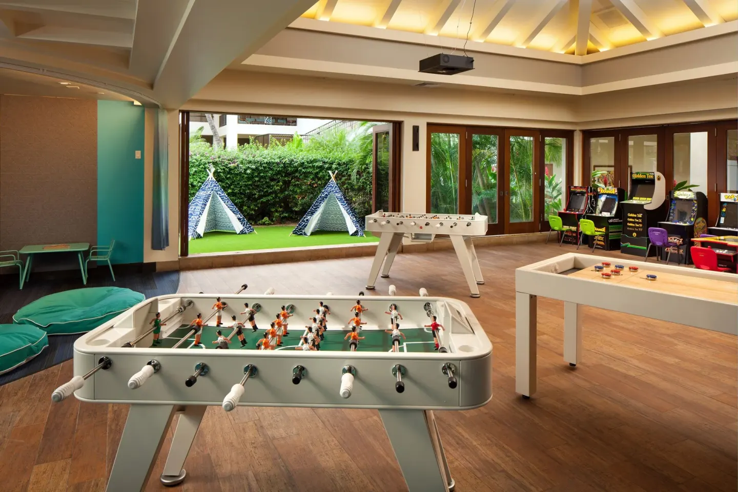 A game room with foosball, air hockey, and arcade machines at Sheraton Maui Resort & Spa.