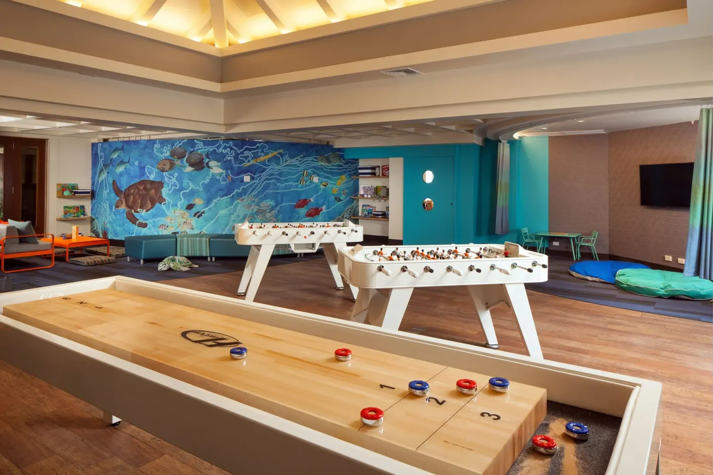 Game room with shuffleboard, foosball and ocean mural at Sheraton Maui Resort & Spa.