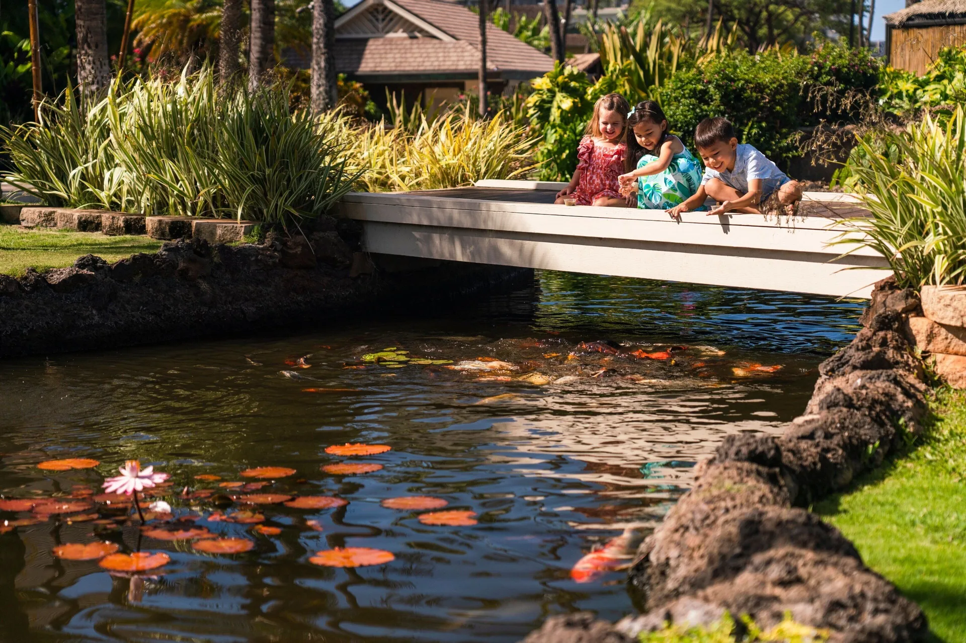 Children watching koi from a bridge at Sheraton Maui Resort & Spa.