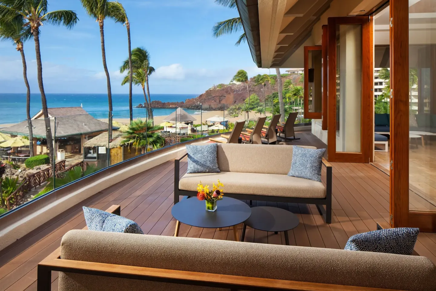 Oceanfront terrace seating with sofas and beach views at Sheraton Maui Resort & Spa.