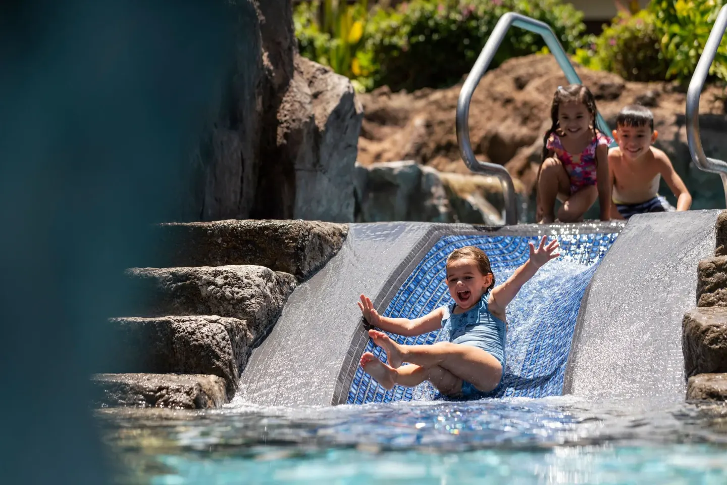 Children sliding into the pool at Sheraton Maui Resort & Spa.