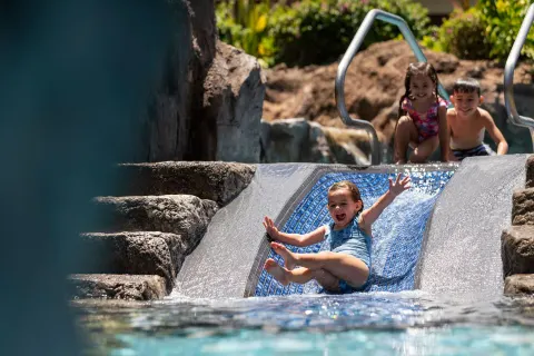 Children sliding into the pool at Sheraton Maui Resort & Spa.