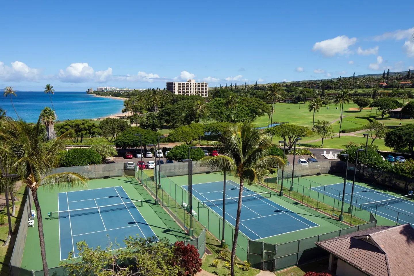 Tennis courts overlook the coast and greenery at Sheraton Maui Resort & Spa.