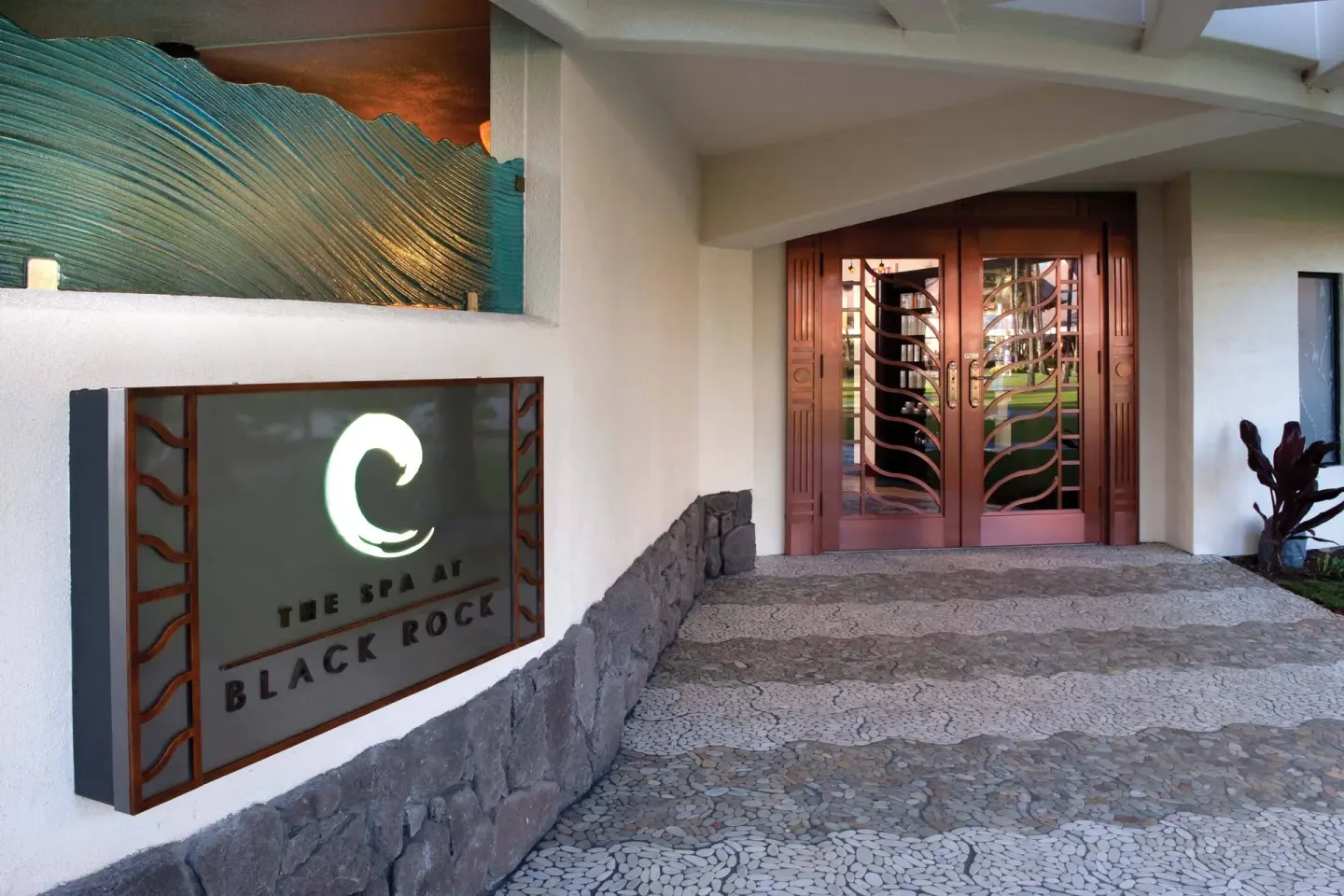 The Spa at Black Rock sign and carved wood doors at Sheraton Maui Resort & Spa.