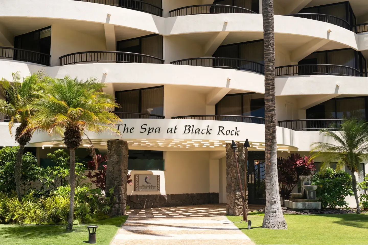 The Spa at Black Rock exterior with balconies and fountain at Sheraton Maui Resort & Spa.
