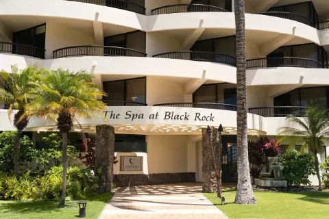 The Spa at Black Rock exterior with balconies and fountain at Sheraton Maui Resort & Spa.