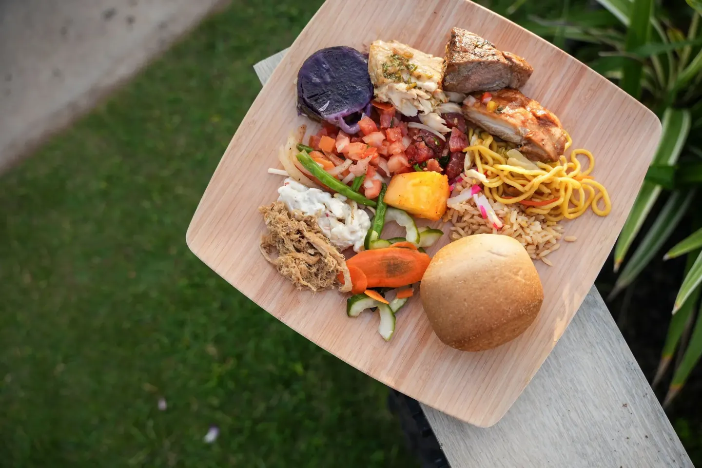 Luau buffet plate with meats, noodles, rice, vegetables and bread at Sheraton Maui Resort & Spa.
